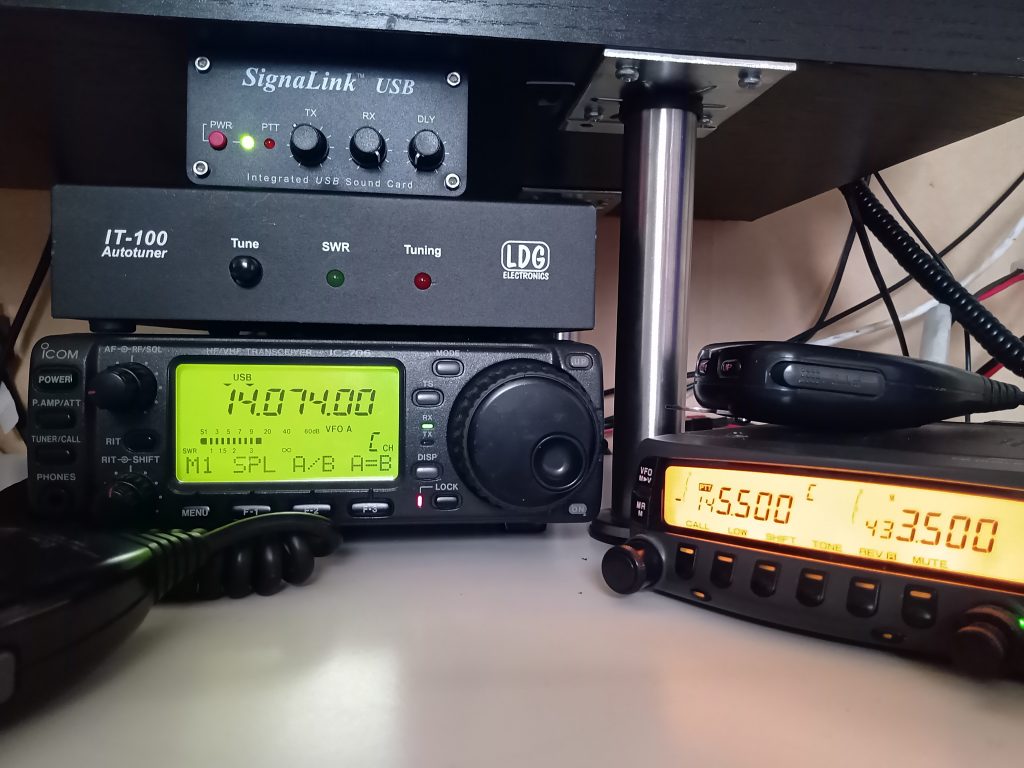 SignaLink atop IT-100 autotuner atop ICOM-706, beside a Kenwood TM-733.