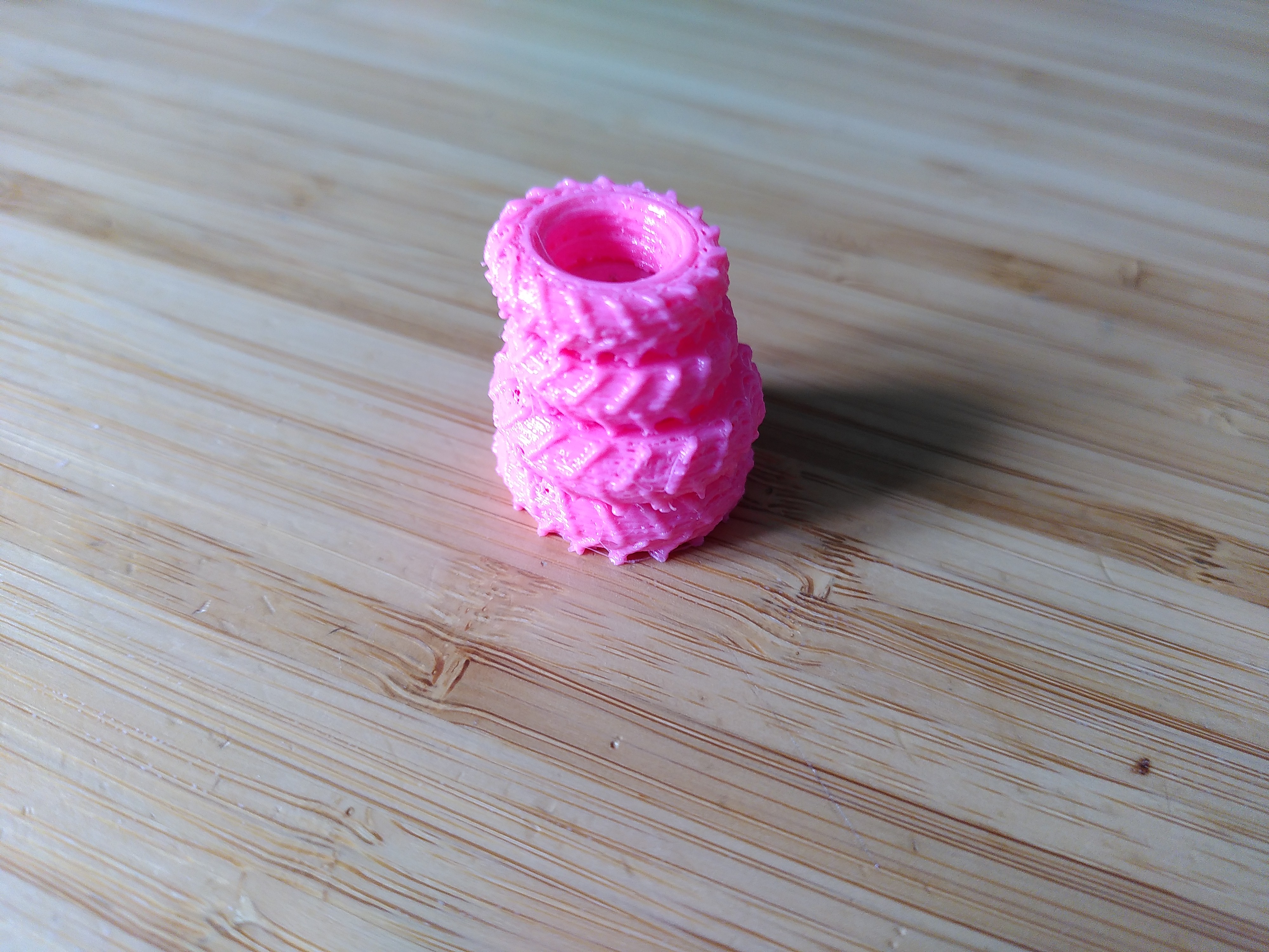 A stack of four pink tractor tyres